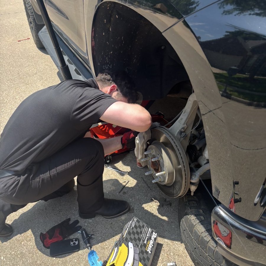 Jacob replacing brake pads on a customer's truck